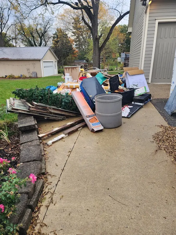 Dumpster being loaded with debris for 12 Yard Dumpster Rental in Boscobel